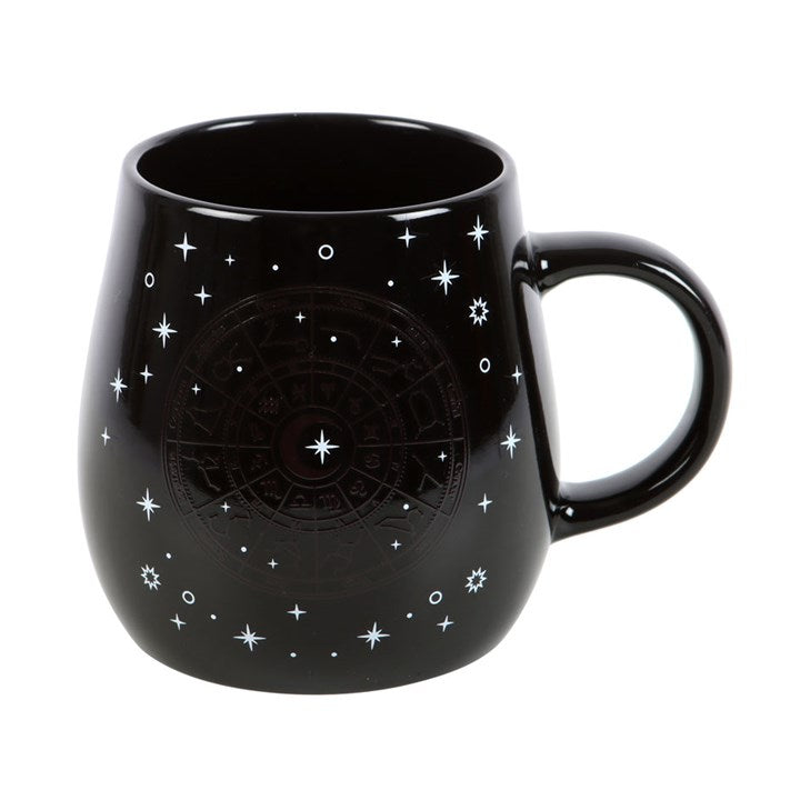 Black heat-changing celestial mug featuring a gold Astrology Wheel design surrounded by twinkling stars. The design appears when a hot beverage is poured in. 500ml capacity, dishwasher safe, not microwave safe