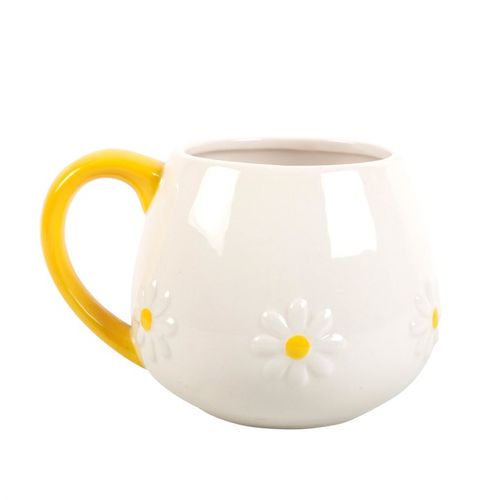 White ceramic mug with embossed daisy flower details and a vibrant yellow handle, perfect for adding a touch of cheer to your coffee or tea moments