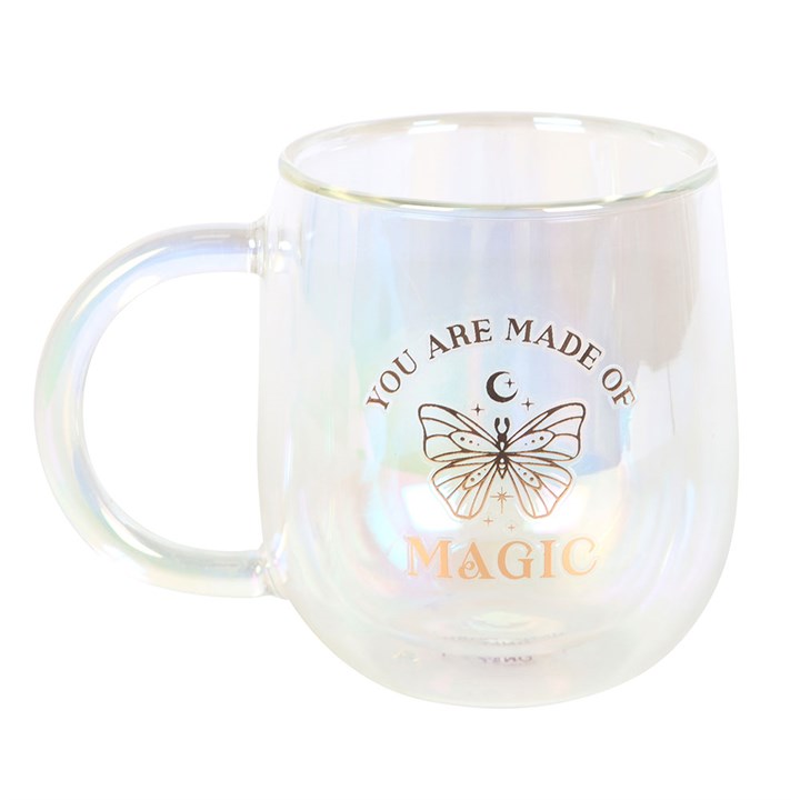A clear double-walled glass mug with an iridescent interior, featuring a gold butterfly design and the phrase "You are made of magic" in gold lettering. The mug has a smooth handle and a modern, rounded shape.