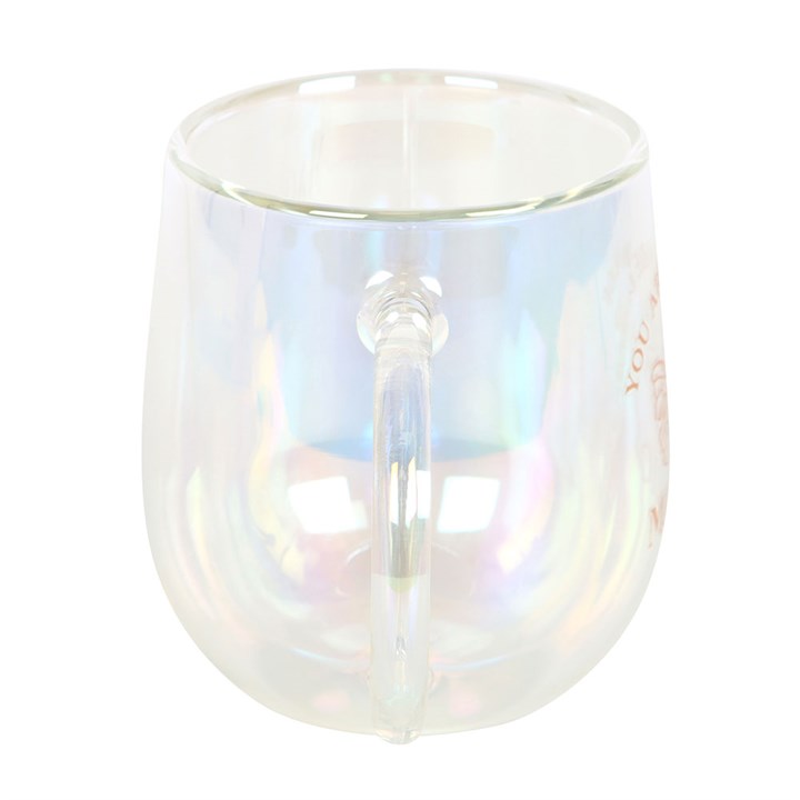 A clear double-walled glass mug with an iridescent interior, featuring a gold butterfly design and the phrase "You are made of magic" in gold lettering. The mug has a smooth handle and a modern, rounded shape.