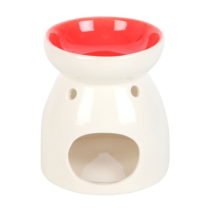 Ceramic wax melt burner with 'All You Need Is Love' text, featuring a heart-shaped cutout glowing with a tealight candle and a red interior bowl. Perfect for home fragrance lovers to create a cozy and romantic ambiance