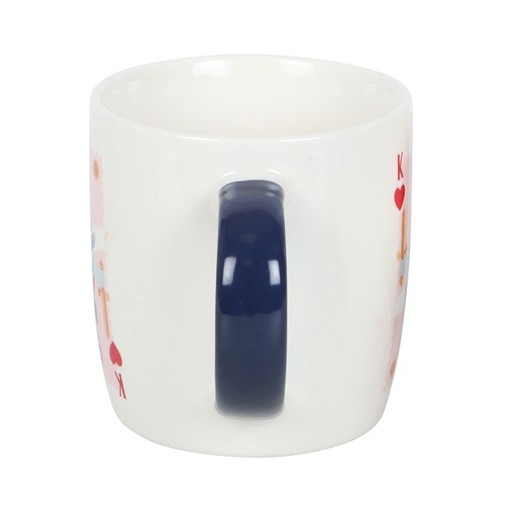 A white ceramic mug with a navy handle, featuring a king of hearts playing card illustration and the phrase “His Lordship.” The mug sits on a round white tray, offering a refined and playful design perfect for the royal gentleman in your life.