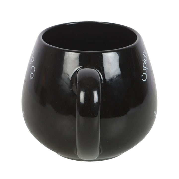 Black ceramic Love Potion heat change mug featuring 'Cupid's Brewing Co.' design with a heart-shaped potion bottle graphic that changes color when filled with a hot beverage.