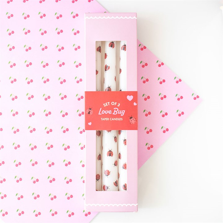 Set of 3 Love Bug taper candles with adorable ladybird designs, packaged in a pink box with a heart-themed label, perfect for romantic or whimsical decor