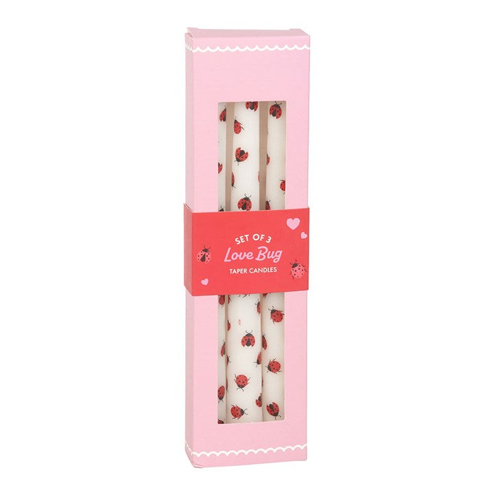 Set of 3 Love Bug taper candles with adorable ladybird designs, packaged in a pink box with a heart-themed label, perfect for romantic or whimsical decor