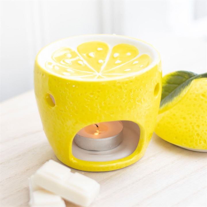 Bright yellow ceramic lemon oil burner with a textured surface and lemon slice design on top, perfect for melting wax or diffusing essential oils to create a refreshing ambiance