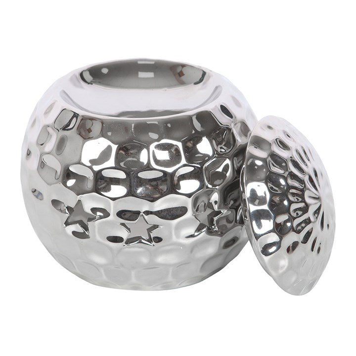 Silver disco ball oil burner with a hammered metallic finish and star-shaped cutouts, perfect for creating a stylish and modern ambiance with wax melts or essential oils