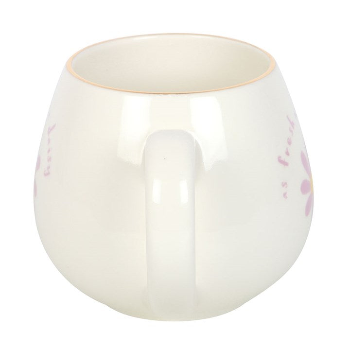 White ceramic mug with 'As fresh as a daisy' text and a purple daisy design with a yellow center. Perfect for tea or coffee, adding a touch of floral charm to your daily routine.