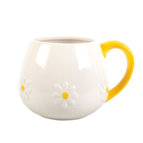 White ceramic mug with embossed daisy flower details and a vibrant yellow handle, perfect for adding a touch of cheer to your coffee or tea moments
