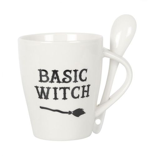 White ceramic mug with 'Basic Witch' text and a broom design, accompanied by a matching spoon featuring a crescent moon and stars. Dishwasher and microwave safe, perfect for witchy and Halloween lovers.
