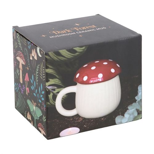 A novelty ceramic mug shaped like a mushroom, with a cream-colored base and a glossy red lid topped with white polka dots. The design mimics a toadstool, giving it a playful, whimsical look.