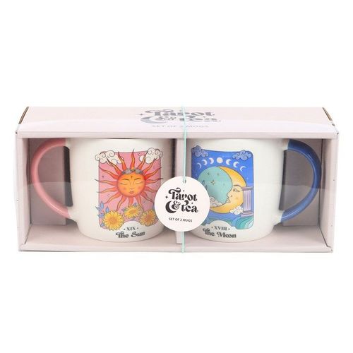 A set of two ceramic mugs inspired by tarot cards. One mug features the Sun card with a bright sun face, pink handle, and floral accents. The other displays the Moon card with a crescent moon and serene night sky, paired with a blue handle. Both have a white base and colourful celestial artwork.