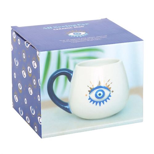White rounded ceramic mug featuring a striking All-Seeing Eye design with metallic gold accents, symbolizing protection, good luck, and positive energy. 500ml capacity.