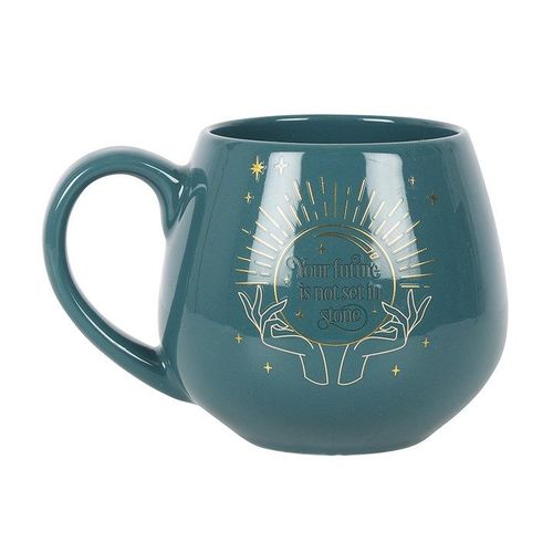 A dark green ceramic mug with a rounded shape and a gold mystical crystal ball design. The phrase “Your future is not set in stone” appears within the crystal ball. The mug features a color-change element that reveals the hidden message when filled with a hot drink.