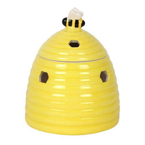 Yellow ceramic beehive-shaped oil burner with hexagonal cutouts and a cute bee accent on top, perfect for diffusing essential oils or wax melts to create a cozy atmosphere