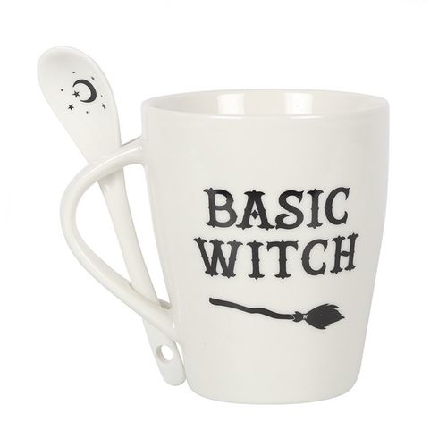 White ceramic mug with 'Basic Witch' text and a broom design, accompanied by a matching spoon featuring a crescent moon and stars. Dishwasher and microwave safe, perfect for witchy and Halloween lovers.