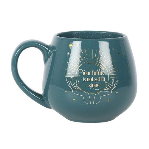 A dark green ceramic mug with a rounded shape and a gold mystical crystal ball design. The phrase “Your future is not set in stone” appears within the crystal ball. The mug features a color-change element that reveals the hidden message when filled with a hot drink.