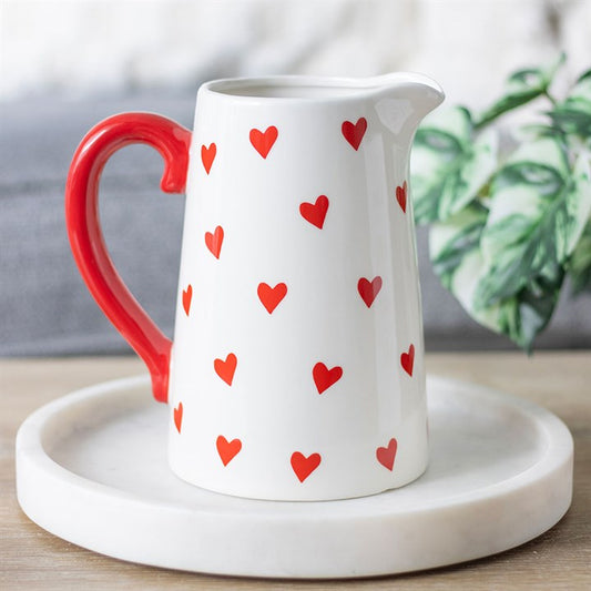 Heart Print Ceramic Flower Vase with a white base, red heart pattern, and a vibrant red handle. Perfect for displaying fresh flowers or as a decorative centerpiece for your home.