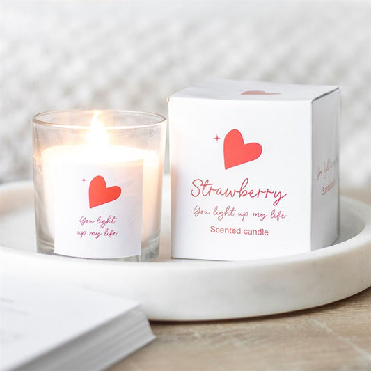You Light Up My Life strawberry scented candle in a clear glass jar with a red heart design and matching white gift box, perfect for romantic occasions or thoughtful gifts