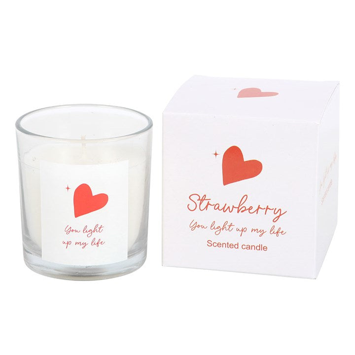 You Light Up My Life strawberry scented candle in a clear glass jar with a red heart design and matching white gift box, perfect for romantic occasions or thoughtful gifts