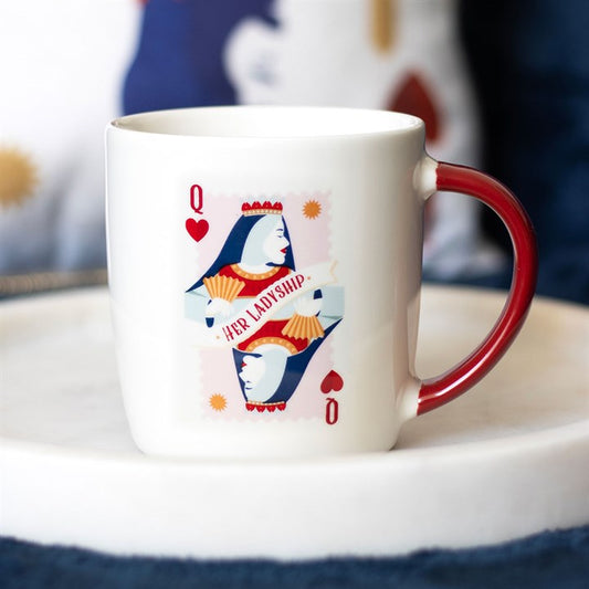 A white ceramic mug with a red handle featuring a queen of hearts playing card design and the phrase “Her Ladyship.” The mug sits on a white circular tray, offering a classy and playful tribute to the leading lady in your life.