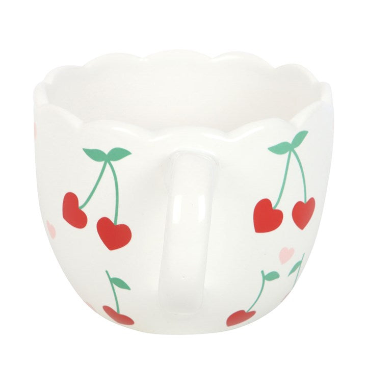 White ceramic scalloped mug featuring a charming cherry print design, perfect for enjoying coffee, tea, or hot cocoa with a touch of whimsy