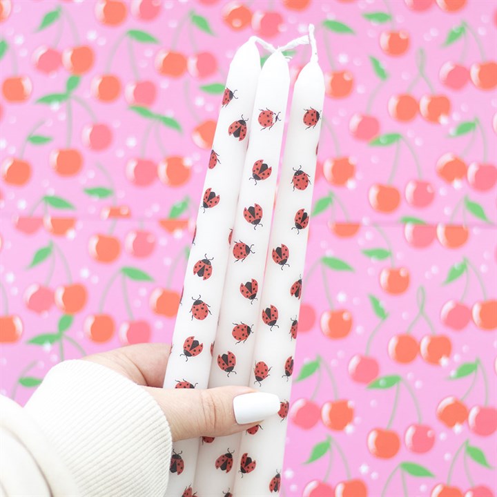 Set of 3 Love Bug taper candles with adorable ladybird designs, packaged in a pink box with a heart-themed label, perfect for romantic or whimsical decor