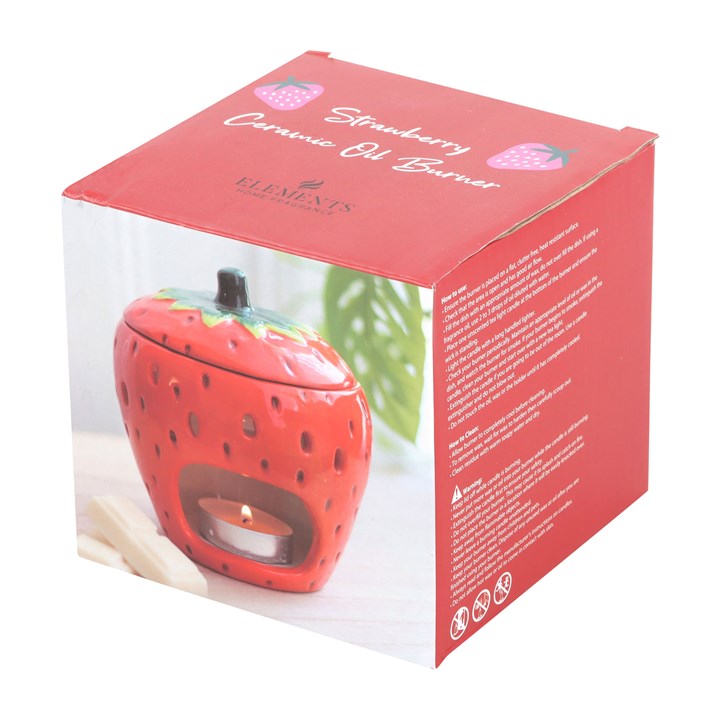 A ceramic strawberry-shaped oil burner with a removable lid, featuring a glossy red finish with tiny seed details and a green leafy top. The playful and vibrant design makes it a charming addition to any home décor.