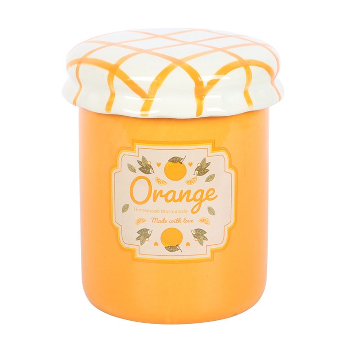 A vintage-style orange marmalade oil burner and wax warmer designed to resemble a jam jar, featuring a bright orange finish, a charming fruit label, and a white ceramic lid with a yellow crisscross pattern.