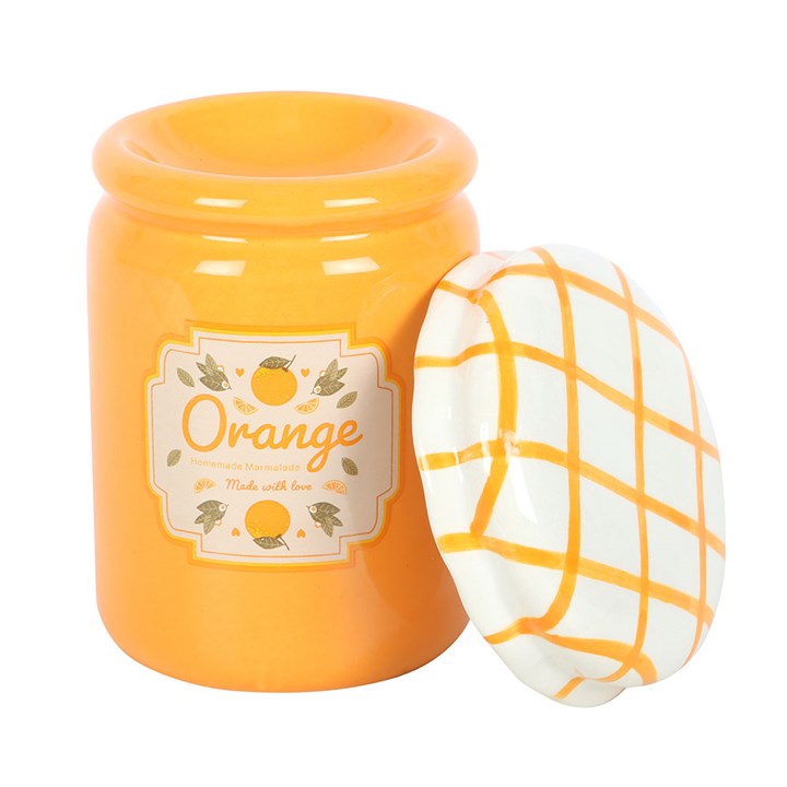 A vintage-style orange marmalade oil burner and wax warmer designed to resemble a jam jar, featuring a bright orange finish, a charming fruit label, and a white ceramic lid with a yellow crisscross pattern.
