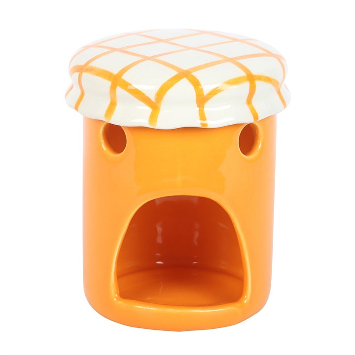A vintage-style orange marmalade oil burner and wax warmer designed to resemble a jam jar, featuring a bright orange finish, a charming fruit label, and a white ceramic lid with a yellow crisscross pattern.