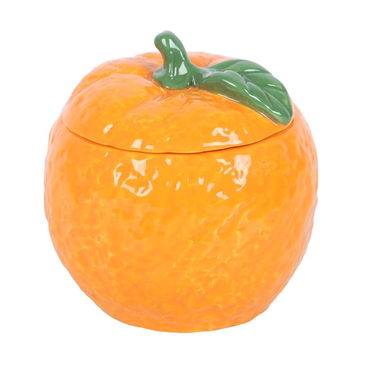 A beautifully designed orange-shaped scented candle housed in a glossy ceramic jar with a removable lid, featuring a green leaf accent. 
