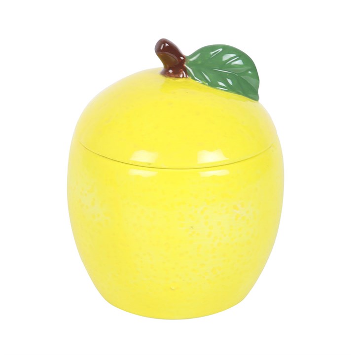 A lemon-shaped scented candle in a glossy ceramic jar with a removable lid, featuring a green leaf accent. 