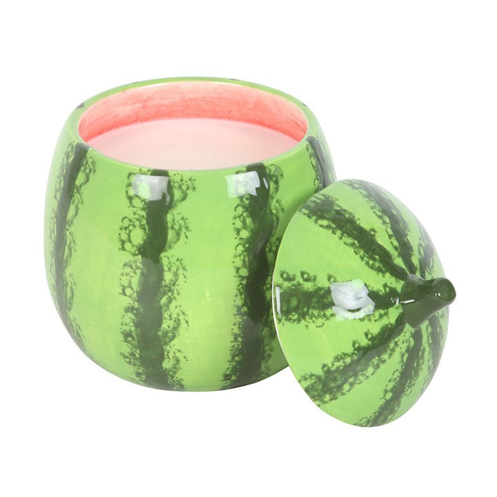 A watermelon-shaped scented candle in a glossy ceramic jar with a removable lid, featuring a realistic green rind design.