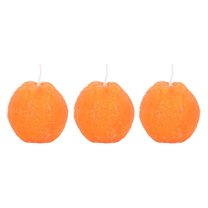 A set of three unscented, orange-shaped candles with a textured surface, placed on a wooden board. The candles have a bright orange hue and white wicks, resembling real oranges.