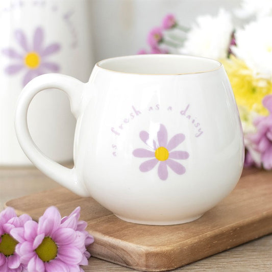 White ceramic mug with 'As fresh as a daisy' text and a purple daisy design with a yellow center. Perfect for tea or coffee, adding a touch of floral charm to your daily routine.