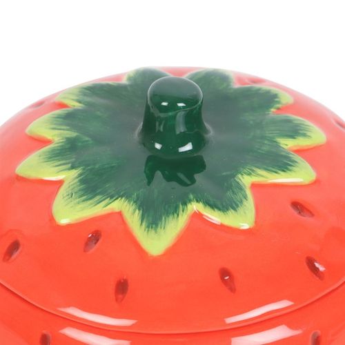 A ceramic strawberry-shaped oil burner with a removable lid, featuring a glossy red finish with tiny seed details and a green leafy top. The playful and vibrant design makes it a charming addition to any home décor.