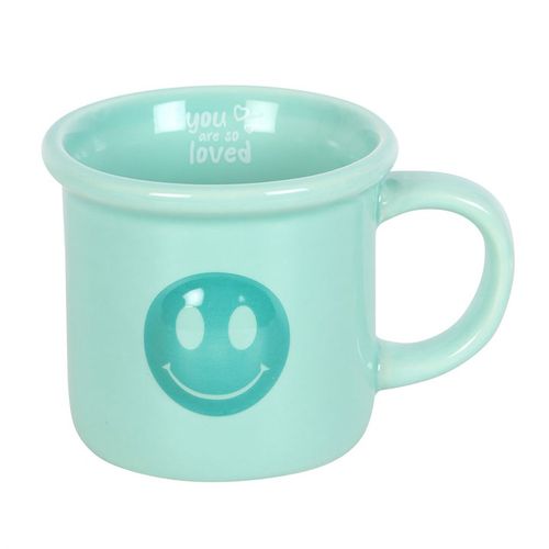 Mint green ceramic mug featuring a happy face design on the front and an uplifting 'You are so loved' message inside the rim, perfect for brightening your day or as a thoughtful gift