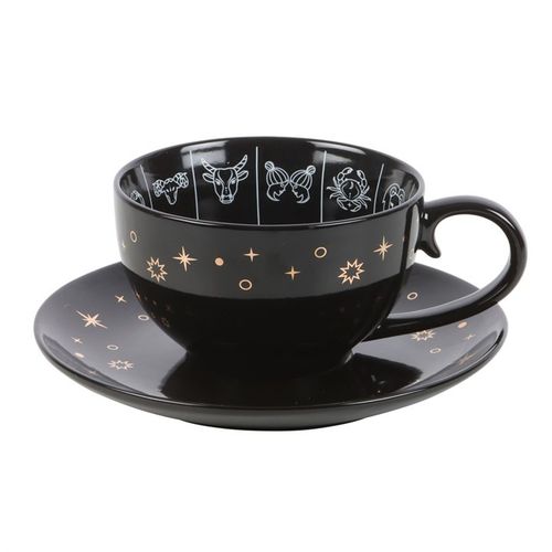 Black celestial teacup and saucer set featuring an astrology wheel with zodiac signs in white and gold detailing, designed for tea leaf reading and divination. 500ml capacity