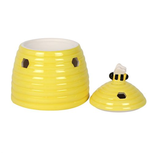 Yellow ceramic beehive-shaped oil burner with hexagonal cutouts and a cute bee accent on top, perfect for diffusing essential oils or wax melts to create a cozy atmosphere