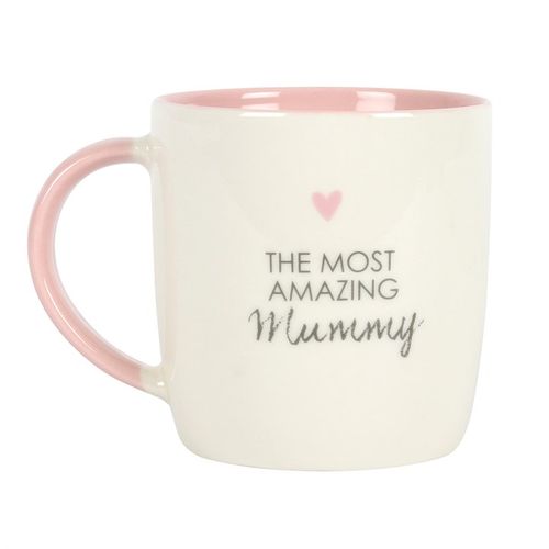 White ceramic mug with a pink handle and interior, featuring 'The Most Amazing Mummy' text and a small pink heart, perfect for Mother's Day or a birthday gift. 500ml capacity, dishwasher and microwave safe