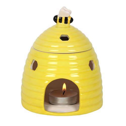 Yellow ceramic beehive-shaped oil burner with hexagonal cutouts and a cute bee accent on top, perfect for diffusing essential oils or wax melts to create a cozy atmosphere